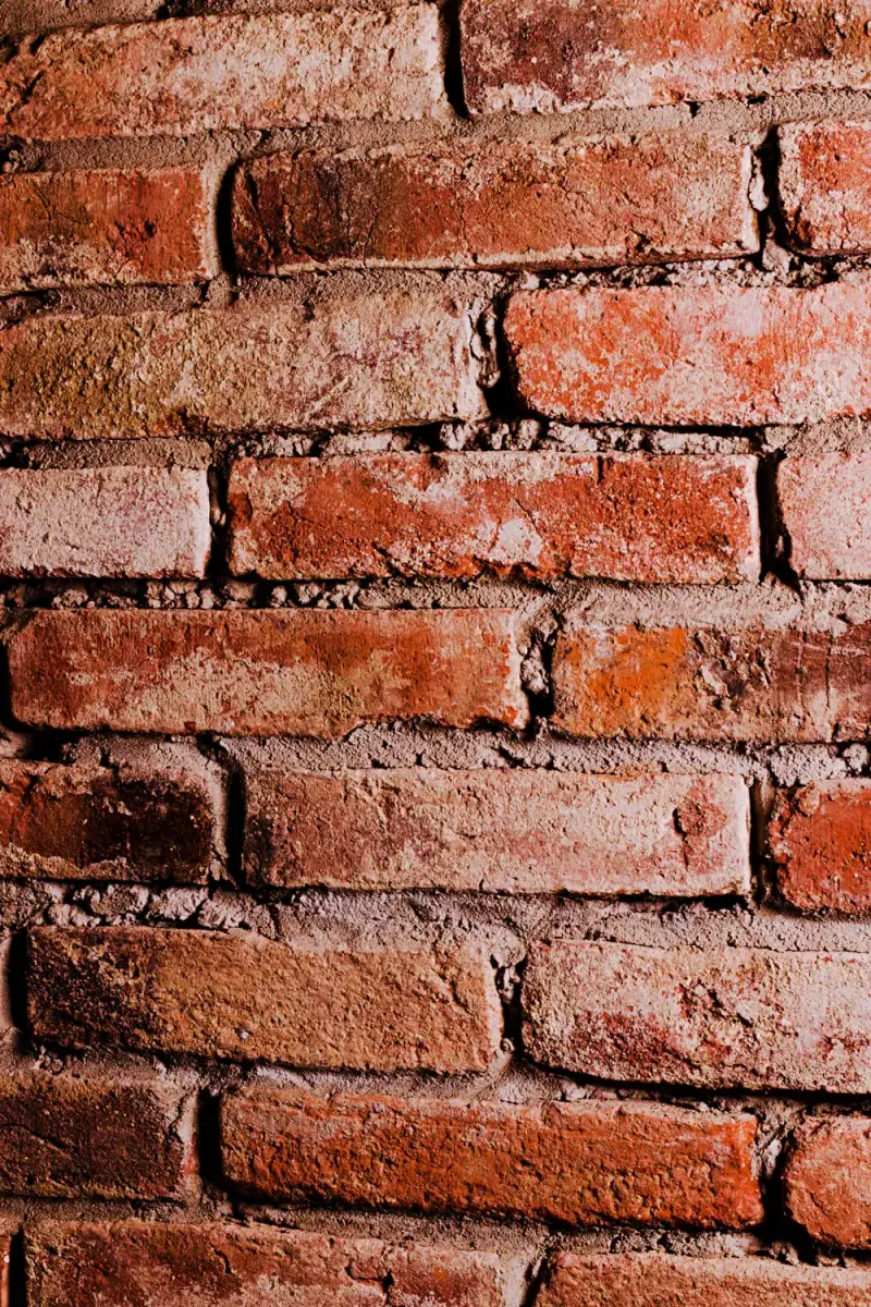 Close view of aged red brick and mortar joints